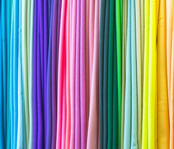 rainbow-colored-fabrics-cotton-scarves-background-2022-11-03-09-18-31-utc